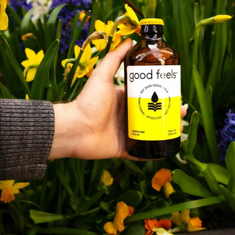 Good Feels beverage in front of spring flowers