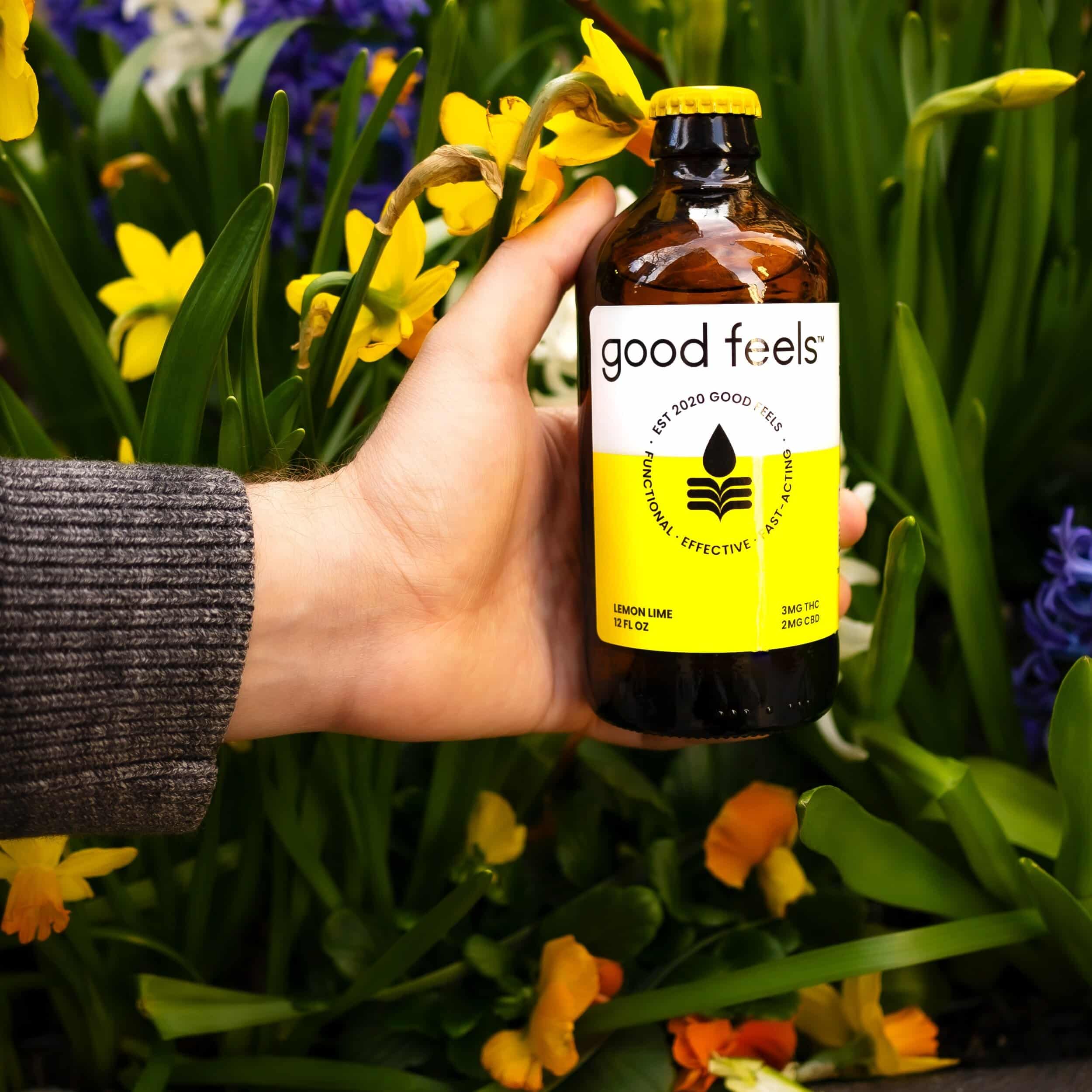 Good Feels beverage in front of spring flowers