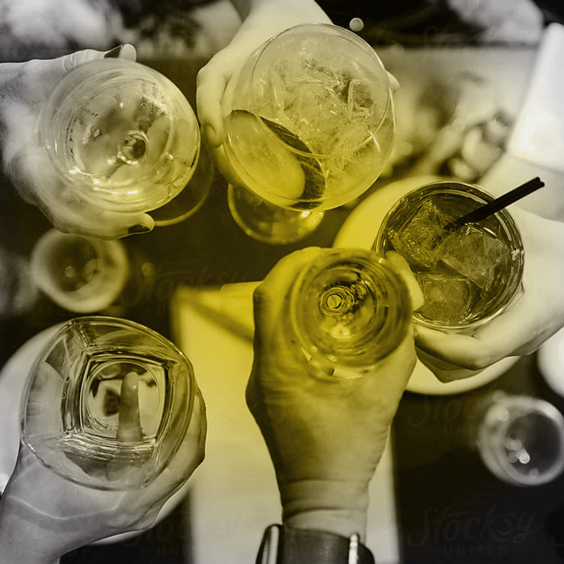 People clinking various beverages all together, from above