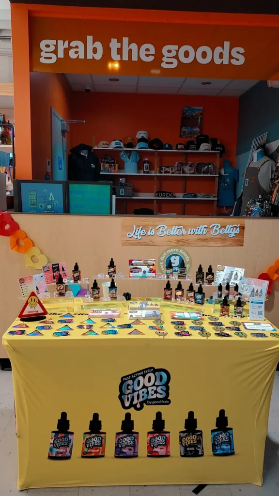 Good Vibes bottles and colorful display cards at The Goods - Somerville.