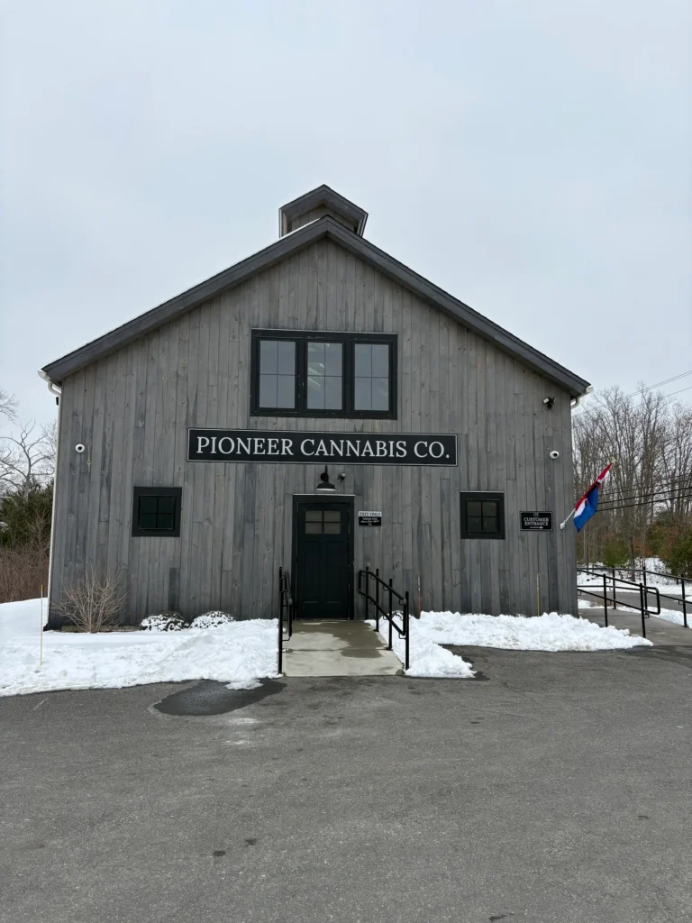 A warm-toned retail display with wood surfaces at Pioneer Cannabis Co - Brimfield.
