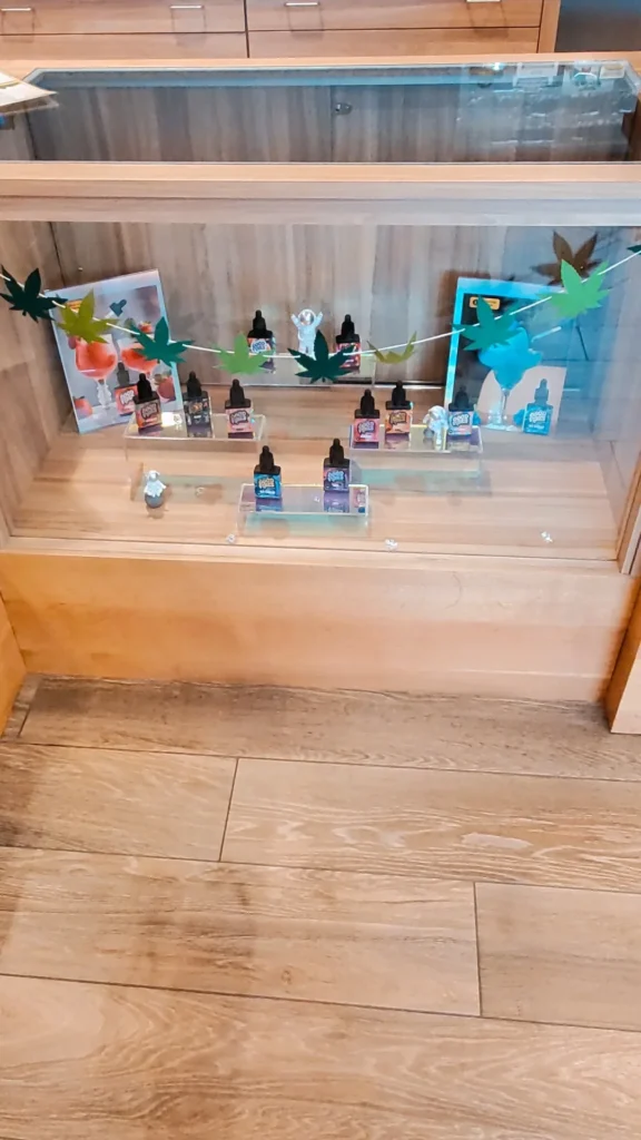 A warm-toned retail display with wood surfaces at Renew Cannabis Co (Berkley).