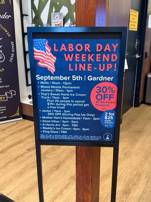 Retail interior and Labor Day weekend event board at Sanctuary Medicinals – Gardner.