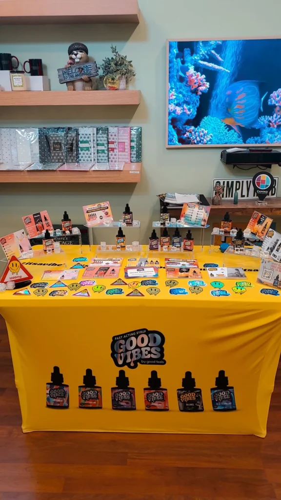 Good Vibes bottles and colorful display cards at Emerald Grove - Eastham.