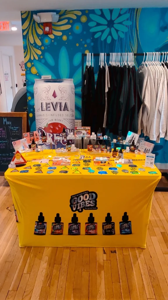 Good Vibes bottles and colorful display cards at Garden Remedies - Newton.