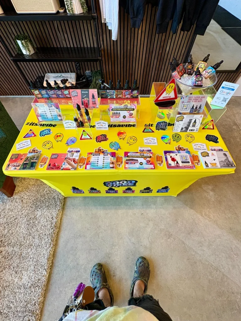 Good Vibes display with Good Vibes packaging and product information at Pinnacle Cannabis – Quincy.