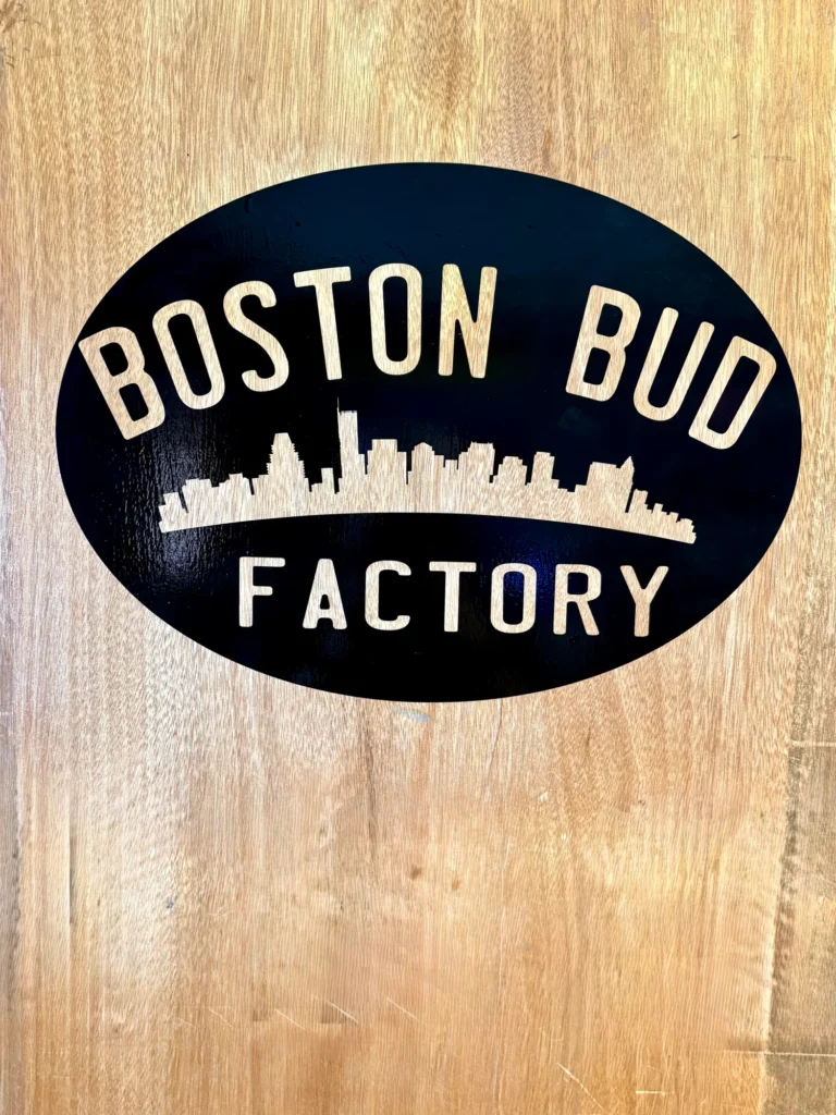 A warm-toned retail display with wood surfaces at Boston Bud Factory - Holyoke.