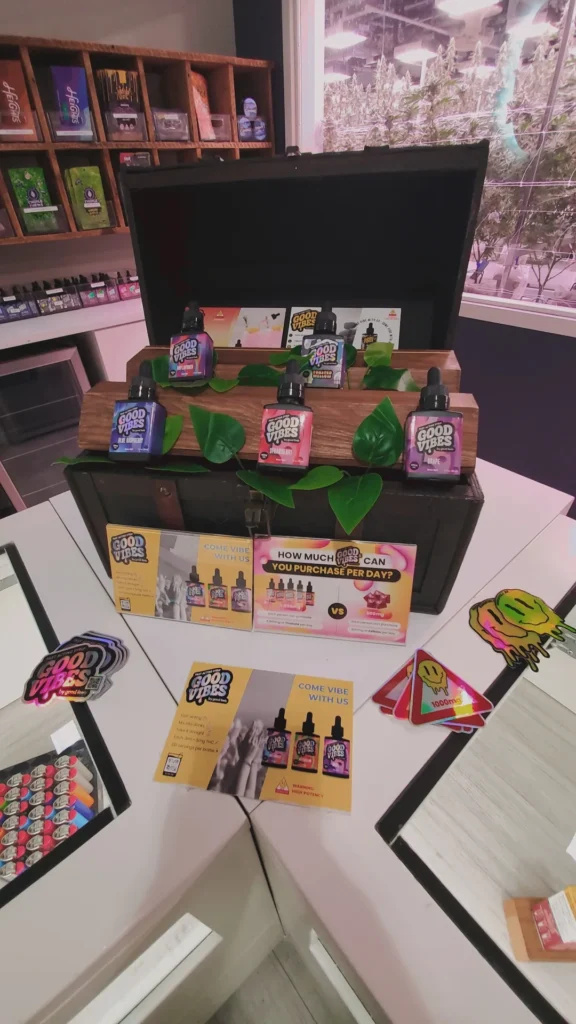 Good Vibes display materials set against warm wood surfaces at Trade Roots - Wareham.