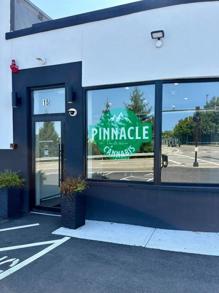Good Vibes display with Good Vibes packaging and product information at Pinnacle Cannabis – Quincy.