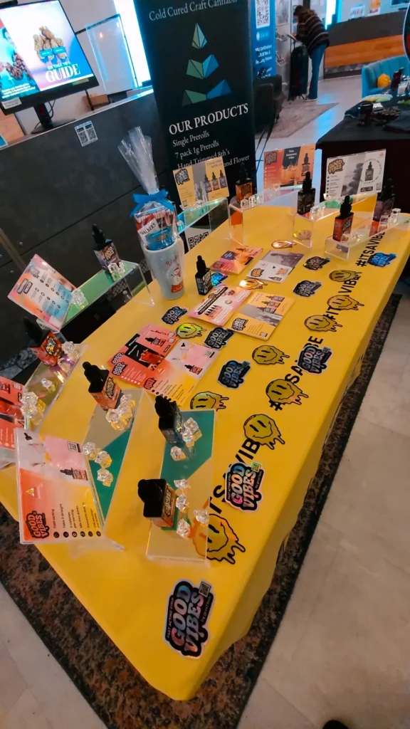 Good Vibes bottles and colorful display cards at NETA - Northampton.