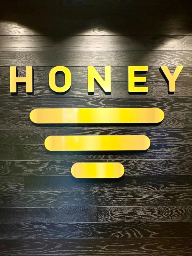 A warm-toned retail display with wood surfaces at Honey - Northampton.