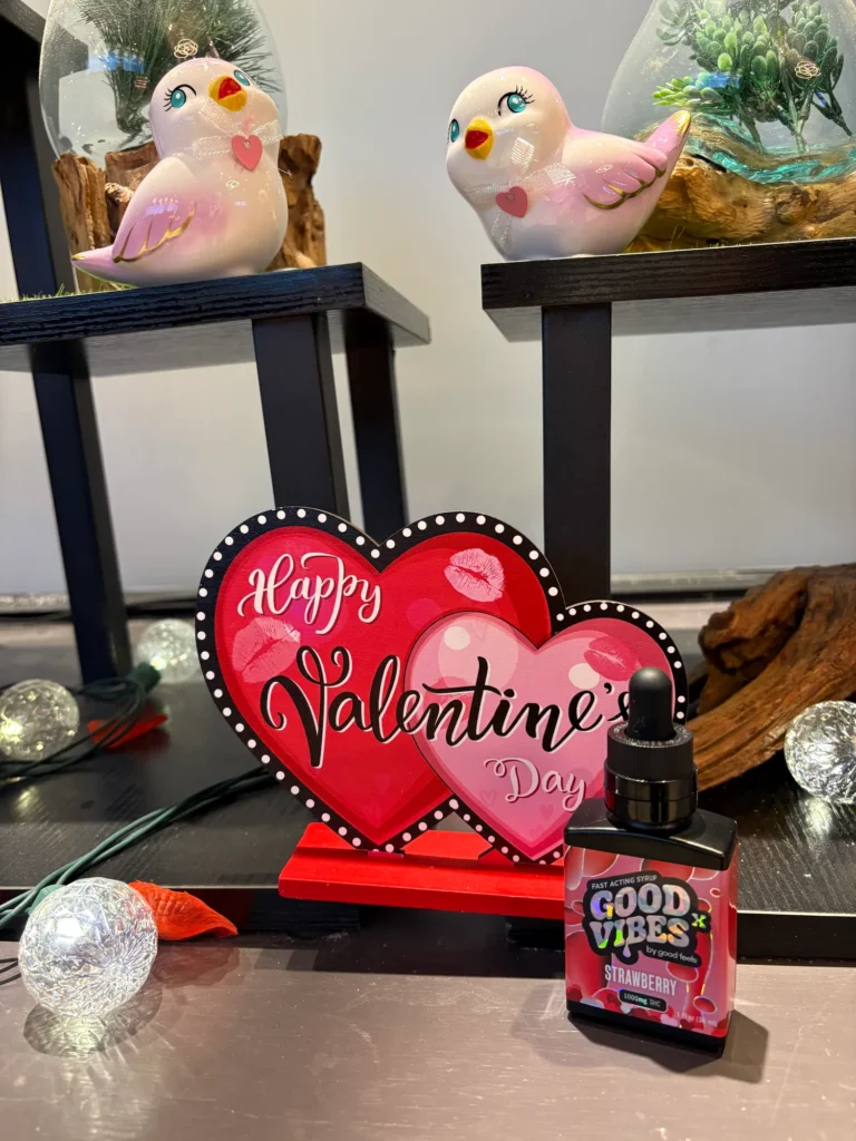Good Vibes display materials set against warm wood surfaces at Terpene Journey.