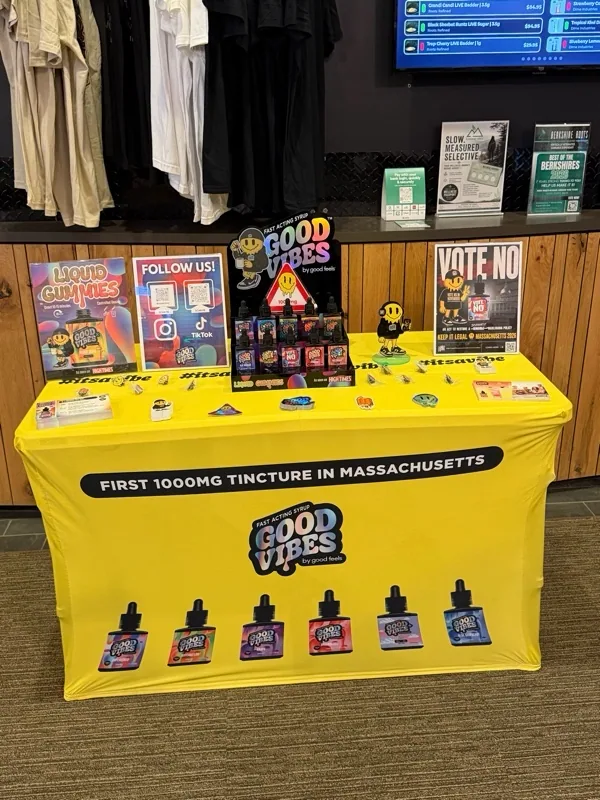 Vibrant yellow Good Vibes pop-up table inside Berkshire Roots – Pittsfield.