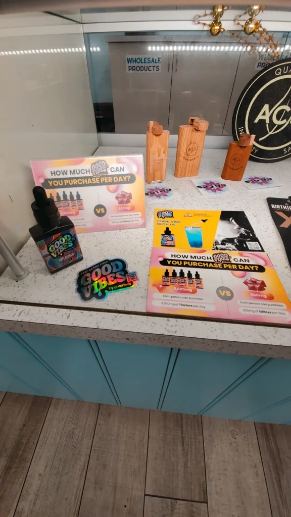 Good Vibes display materials set against warm wood surfaces at Alternative Compassion Services - Medical Only - Hull.