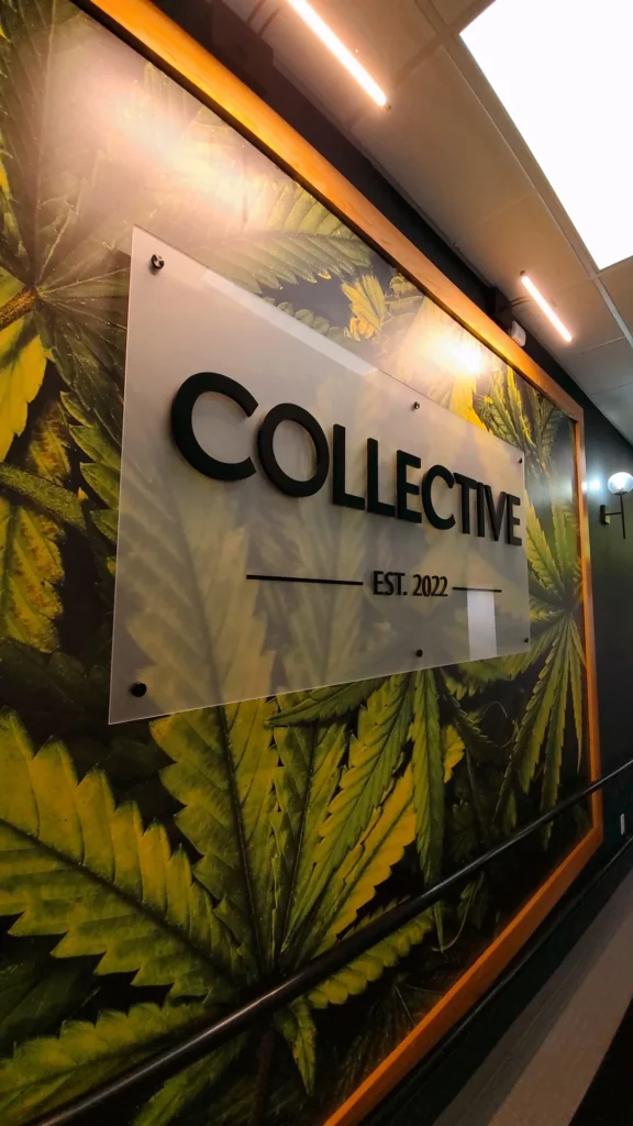 A warm-toned retail display with wood surfaces at Collective Premium Cannabis - Littleton.