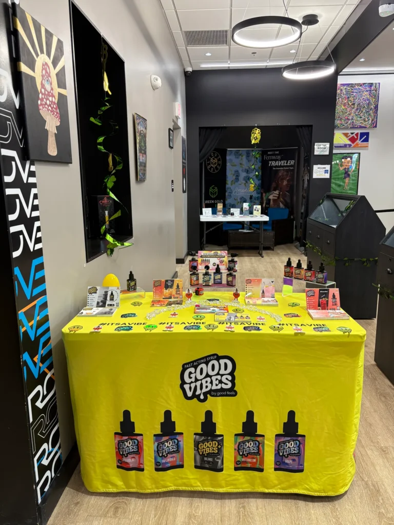 Good Vibes display materials set against warm wood surfaces at New England Harvest - Clinton.