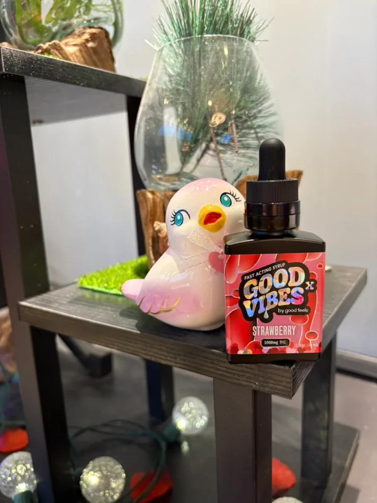Good Vibes display materials set against warm wood surfaces at Terpene Journey.
