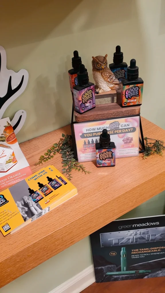 Good Vibes bottles and colorful display cards at Emerald Grove - Eastham.