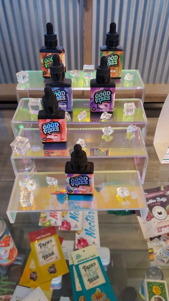 Good Vibes bottles and colorful display cards at Lowell Cannabis Co..