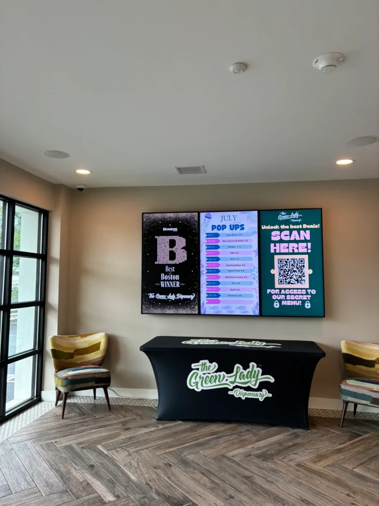 Bright retail display featuring products and signage at The Green Lady Dispensary – Newton.