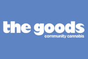 Logo with the words “the goods” in bold white letters on a blue background, with smaller text “community cannabis” underneath.